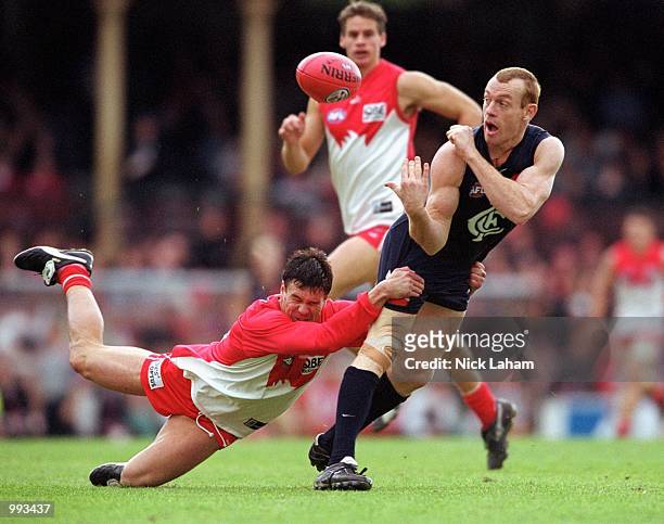 Brad Seymour for Sydney tackles Adrian Hickmott for Carlton during round 14 of the AFL season match played between the Sydney Swans and the Carlton...