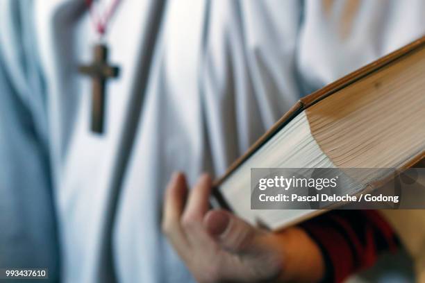 saint-jacques church.  catholic mass.  altar boy with lectionary.  sallanches. france. - altar boy stock pictures, royalty-free photos & images