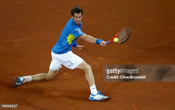 Andy Murray of Great Britain plays a backhand against David Ferrer of Spain in their quarter final match during the Mutua Madrilena Madrid Open...