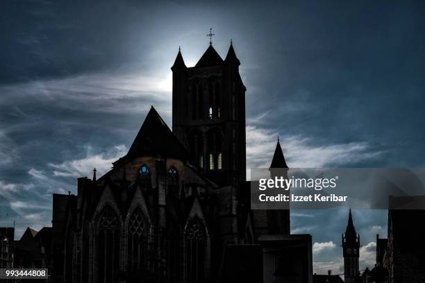 silhouette of st nicholas church in ghent , flanders, belgium - st nicholas church stock-fotos und bilder