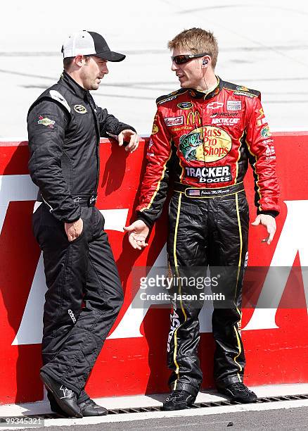 Casey Mears, driver of the Red Bull Toyota, talks with Jamie McMurray, driver of the Bass Pro Shops Chevrolet, as they stand on the grid during...