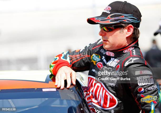 Jeff Gordon, driver of the DuPont Chevrolet, climbs out of his car after qualifying for the NASCAR Sprint Cup Series Autism Speaks 400 at Dover...