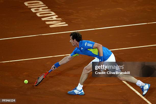 Andy Murray of Great Britain stretches to play a forehand volley against David Ferrer of Spain in their quarter final match during the Mutua...