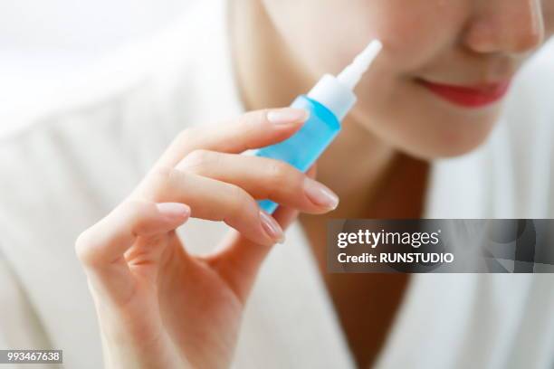 woman applying anti-aging serum on face - runstudio foto e immagini stock