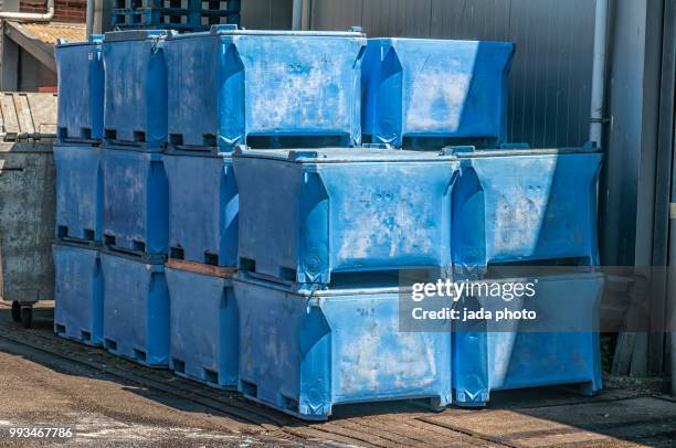 blue plastic storage boxes for storing fish waste - industrial storage bins stock pictures, royalty-free photos & images