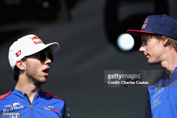 Brendon Hartley of New Zealand and Scuderia Toro Rosso and Pierre Gasly of France and Scuderia Toro Rosso talk to fans on the fan stage after...