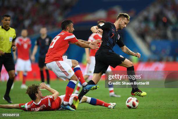 Mario Fernandes of Russia tackles Ivan Rakitic of Croatia as Alexander Samedov of Russia also challenges him during the 2018 FIFA World Cup Russia...