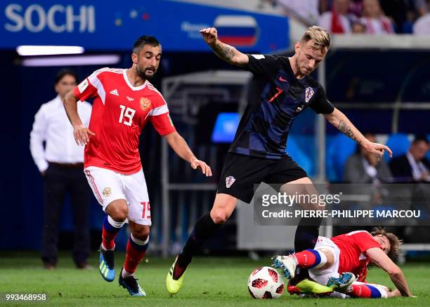 Russia's midfielder Alexander Samedov and Russia's defender Mario Fernandes challenge Croatia's midfielder Ivan Rakitic during the Russia 2018 World...
