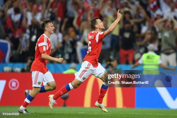 Denis Cheryshev of Russia celebrates after scoring his team's first goal during the 2018 FIFA World Cup Russia Quarter Final match between Russia and...