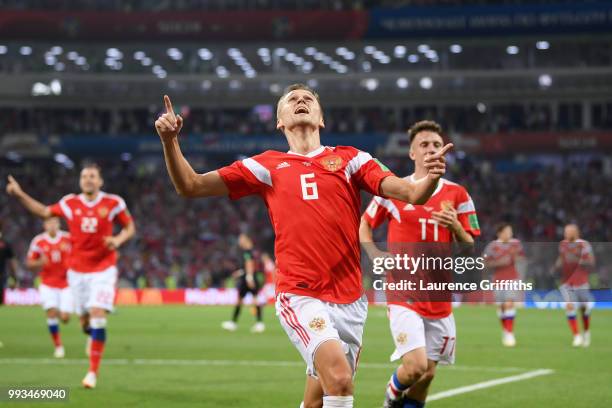 Denis Cheryshev of Russia celebrates with team mate Aleksandr Golovin after scoring his team's first goal during the 2018 FIFA World Cup Russia...