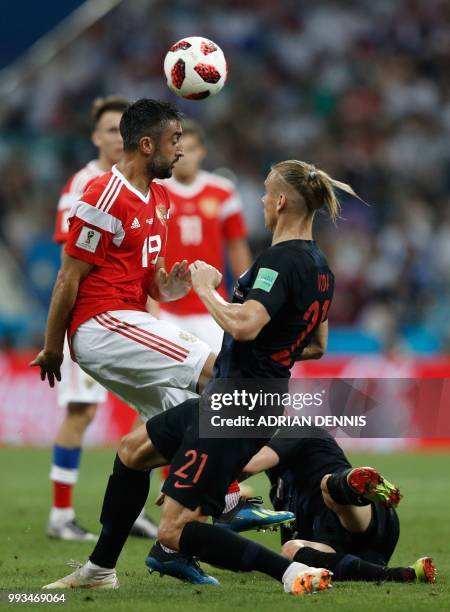 Russia's midfielder Alexander Samedov vies for the header with Croatia's defender Domagoj Vida during the Russia 2018 World Cup quarter-final...