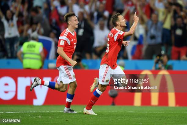 Denis Cheryshev of Russia celebrates with team mate Aleksandr Golovin after scoring his team's first goal during the 2018 FIFA World Cup Russia...