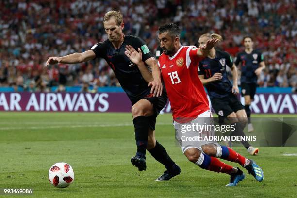 Croatia's defender Ivan Strinic vies for the ball with Russia's midfielder Alexander Samedov during the Russia 2018 World Cup quarter-final football...