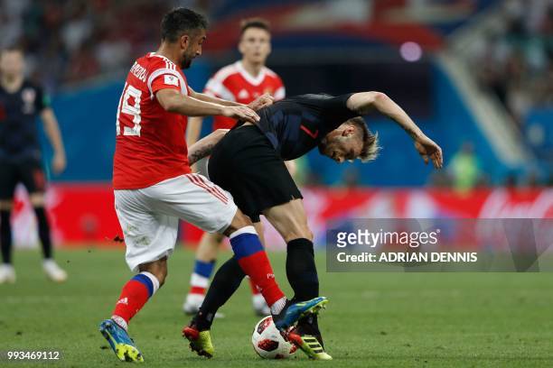 Russia's midfielder Alexander Samedov marks Croatia's midfielder Ivan Rakitic during the Russia 2018 World Cup quarter-final football match between...