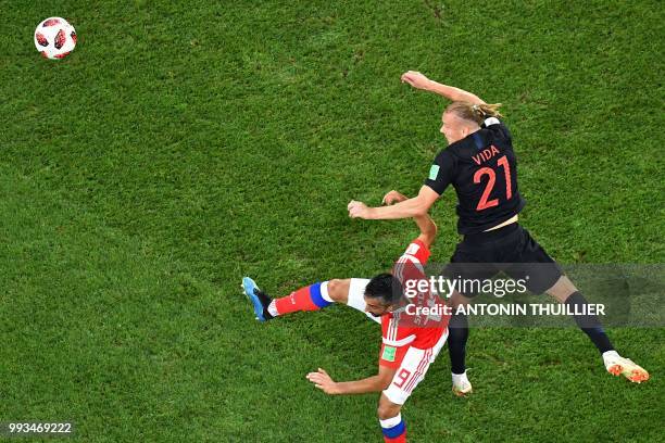 Russia's midfielder Alexander Samedov vies with Croatia's defender Domagoj Vida during the Russia 2018 World Cup quarter-final football match between...