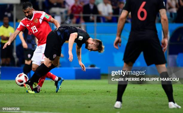 Russia's midfielder Alexander Samedov challenges Croatia's midfielder Ivan Rakitic during the Russia 2018 World Cup quarter-final football match...