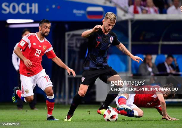 Russia's midfielder Alexander Samedov and Russia's defender Mario Fernandes challenge Croatia's midfielder Ivan Rakitic during the Russia 2018 World...