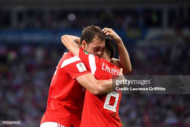 Denis Cheryshev of Russia celebrates with team mate Artem Dzyuba after scoring his team's first goal during the 2018 FIFA World Cup Russia Quarter...