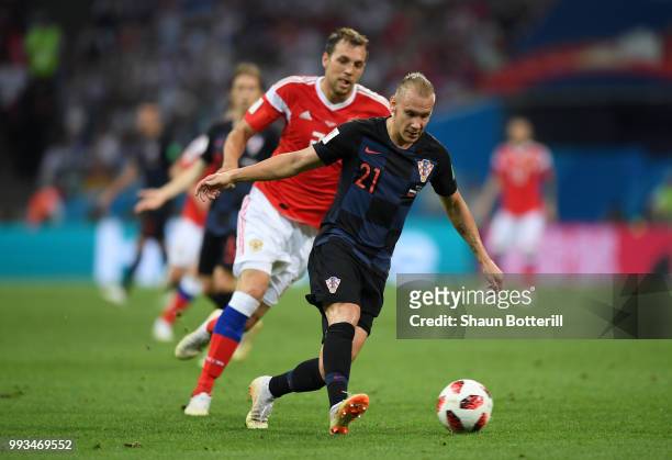 Domagoj Vida of Croatia is challenged by Artem Dzyuba of Russia during the 2018 FIFA World Cup Russia Quarter Final match between Russia and Croatia...