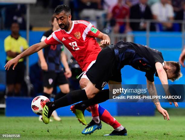 Russia's midfielder Alexander Samedov challenges Croatia's midfielder Ivan Rakitic during the Russia 2018 World Cup quarter-final football match...