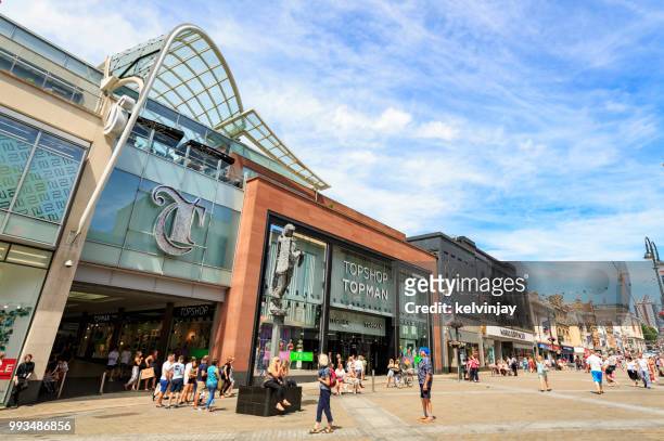 shoppers walking by the trinity shopping centre in leeds - kelvinjay stock pictures, royalty-free photos & images