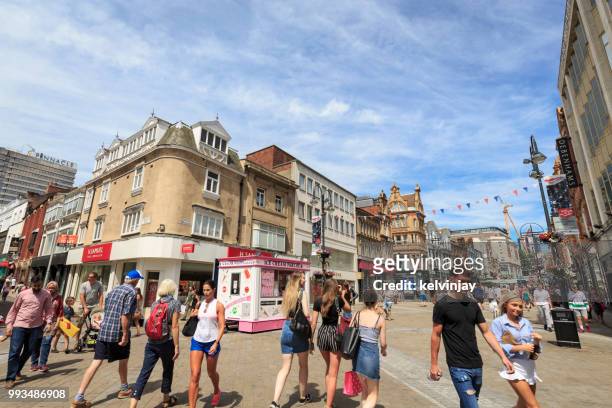 shoppers walking in a pedestrianised area of leeds - kelvinjay stock pictures, royalty-free photos & images