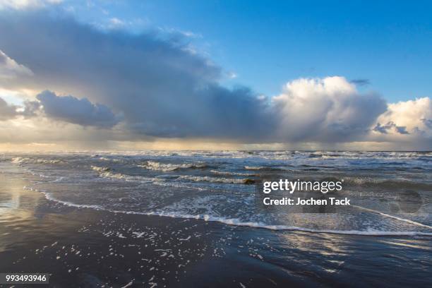 north sea beach, stormy sea, stormy clouds during an autumn storm, de haan, flanders, belgium - haan stock pictures, royalty-free photos & images