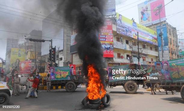 Jan Adhikar Party supporters burn rubber tyres during 'Bihar Bandh' demanding for grant of special status to the state, at Dakbunglow Chowk, on July...