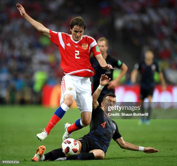 Ivan Perisic of Croatia tackles Mario Fernandes of Russia during the 2018 FIFA World Cup Russia Quarter Final match between Russia and Croatia at...