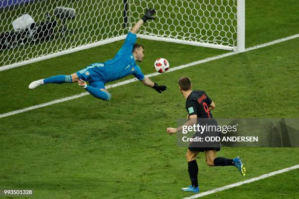 Russia's goalkeeper Igor Akinfeev concedes the equalizer scored by Croatia's forward Andrej Kramaric during the Russia 2018 World Cup quarter-final...