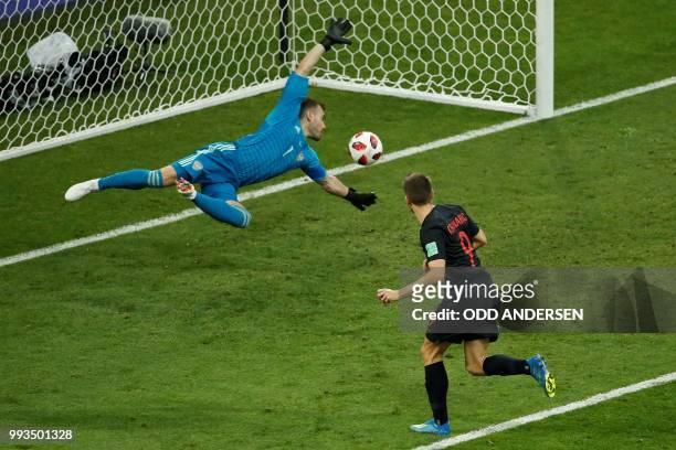 Russia's goalkeeper Igor Akinfeev concedes the equalizer scored by Croatia's forward Andrej Kramaric during the Russia 2018 World Cup quarter-final...