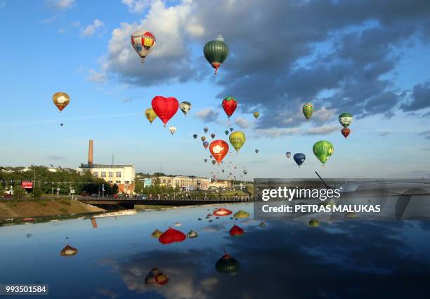 Hot-air balloons fly over Kaunas, Lithuania during the International 100 Hot Air Balloon Fiesta Wind of Freedom on July 7, 2018. - The 'Wind of...