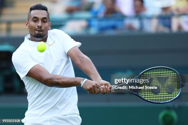 Nick Kyrgios of Australia returns a shot against Kei Nishikori of Japan during their Men's Singles third round match on day six of the Wimbledon Lawn...