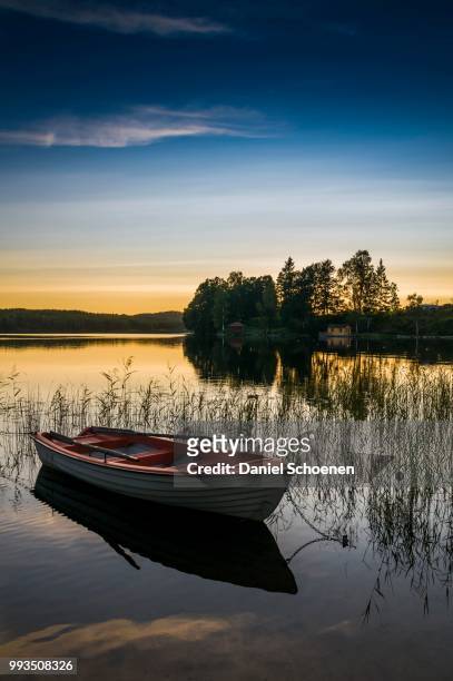 lake and rowing boat at sunset in bengtsfors, dalsland, sweden - dalsland stock pictures, royalty-free photos & images