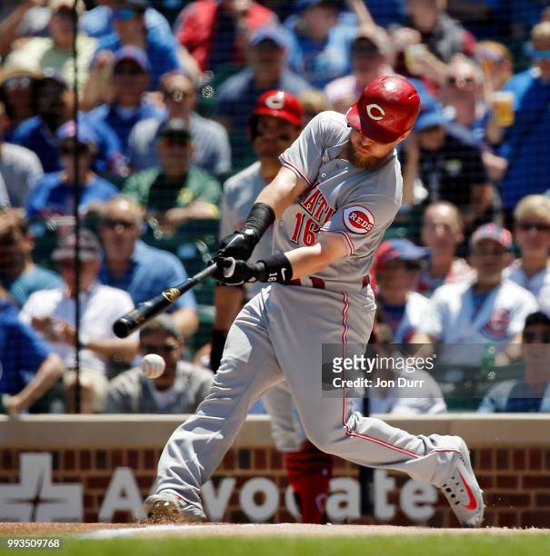 Tucker Barnhart of the Cincinnati Reds hits a single against the Chicago Cubs during the first inning at Wrigley Field on July 7, 2018 in Chicago,...