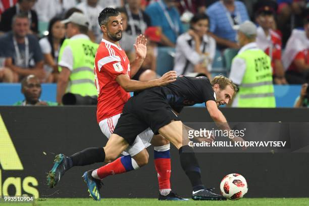 Russia's midfielder Alexander Samedov and Croatia's defender Ivan Strinic vie for the ball during the Russia 2018 World Cup quarter-final football...