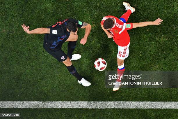 Croatia's defender Dejan Lovren vies with Russia's midfielder Denis Cheryshev during the Russia 2018 World Cup quarter-final football match between...