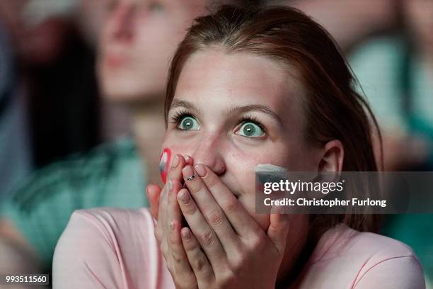 Russian football fans cheer on their team as they watch a giant TV screen at the Samara FIFA fanfest on July 7, 2018 in Samara, Russia. The quarter...