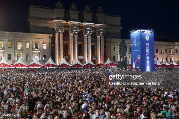 Russian football fans cheer on their team as they watch a giant TV screen at the Samara FIFA fanfest on July 7, 2018 in Samara, Russia. The quarter...