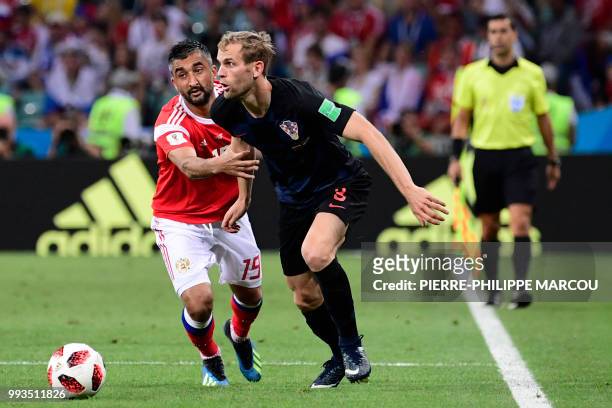 Croatia's defender Ivan Strinic challenges Russia's midfielder Alexander Samedov during the Russia 2018 World Cup quarter-final football match...