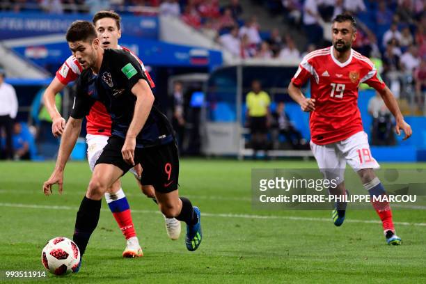 Croatia's forward Andrej Kramaric challenges Russia's midfielder Daler Kuzyaev and Russia's midfielder Alexander Samedov during the Russia 2018 World...