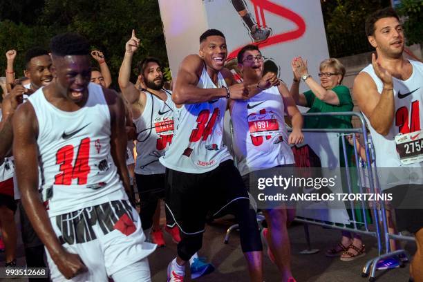 All-Star and Milwaukee Bucks Greek basketball player Giannis Antetokounmpo crosses the finish line of a 5km charity race along with other runners in...