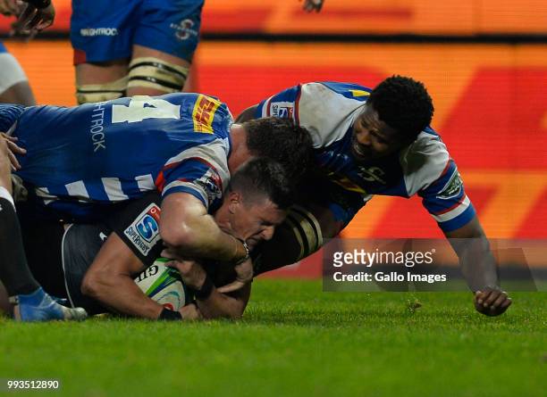 Louis Schreuder of the Sharks tackled by Cobus Wiese and Sikhumbuzo Notshe of the Stormers during the Super Rugby match between DHL Stormers and Cell...