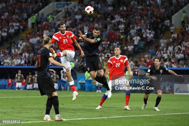 Aleksandr Erokhin of Russia wins a header over Dejan Lovren of Croatia during the 2018 FIFA World Cup Russia Quarter Final match between Russia and...