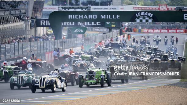 Drivers of 74 cars for a race for vehicles from 1923 to 1939, take part in the 9th edition of Le Mans Classic race in Le Mans, western France on July...