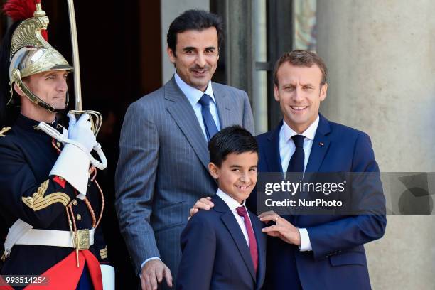 French President Emmanuel Macron welcomes Emir of Qatar Sheikh Tamim bin Hamad Al Thani and his son Hamad at the Elysee Palace in Paris, France on...