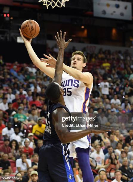 Dragan Bender of the Phoenix Suns drives to the basket against Jalen Jones of the Dallas Mavericks during the 2018 NBA Summer League at the Thomas &...