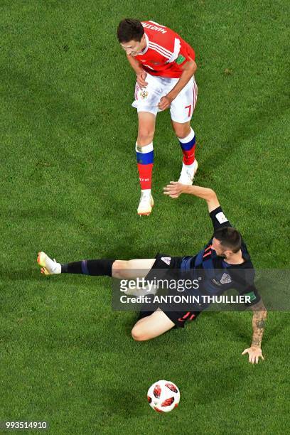 Russia's midfielder Daler Kuzyaev vies with Croatia's midfielder Marcelo Brozovic during the Russia 2018 World Cup quarter-final football match...