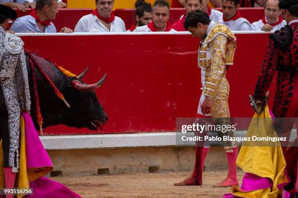 Spanish bullfighter Paco Urena wait for the death of a bull from Puerto de San Lorenzo's fighting bulls after he was gored on his leg when trying to...