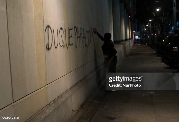 Person writes a reference on a wall about the next president of Colombia, Ivan Duque in Colombia, Bogota on July 6, 2018.